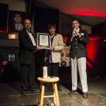 Official GUINNESS WORLD RECORDS™ adjudicator Michael Empric presents the framed certificate to Chad Riden (left) and DJ Buckley (center). PHOTO: Jamie Hernandez